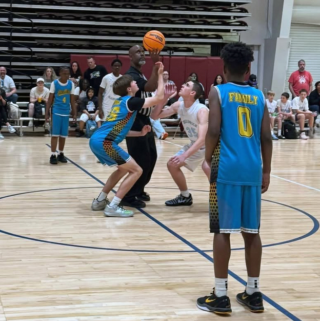Hustlers Elite Boys Kicking Off a Basketball Game