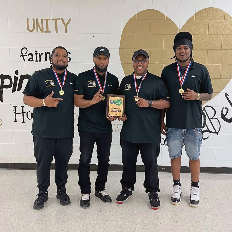 Hustlers Coaches holding an Uptown Tournament Champions Plaque